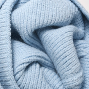 Thick light blue knitted winter beanie hat with warm ribbed texture and fluffy wool finish