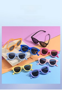 Detailed flat lay of colorful round plastic sunglasses for kids in eight different vibrant shades