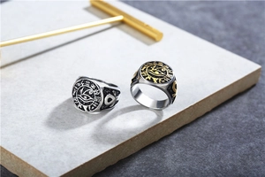 Macro detail of vintage stainless steel Ankh and Eye of Horus relief on a ring band