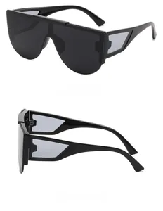 Close-up of black oversized shield sunglasses with unique geometric hollowed-out temples