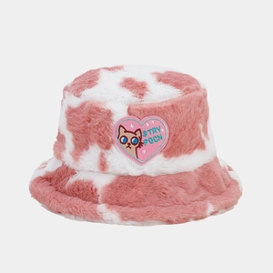 Close-up of pink cow print faux fur bucket hat with heart cat patch and soft texture