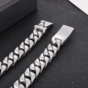 Detailed close-up of 12mm stainless steel Cuban link chain with a secure box clasp