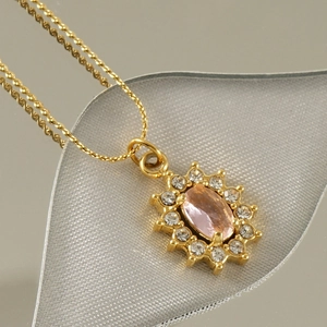 18K gold plated necklace with pink oval gemstone pendant and zircon accents on a textured base