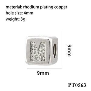 Macro detail of silver letter M charm bead with zircon inlay and 4mm hole diameter