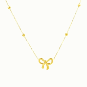 Elegant gold titanium steel necklace featuring a polished bow pendant and bead accents