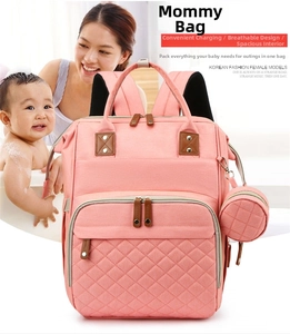 Pink diaper bag with quilted pattern, USB charging port, and breathable back support
