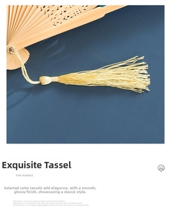 Detailed view of the silk tassel and finely hollowed-out wooden fan ribs of this folding fan