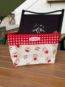 Detail of waterproof PVC organizer bag with cute bear prints and red cherry patterns