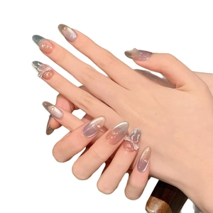 Handmade almond-shaped press-on nails with smoky purple gradient and 3D bow accents