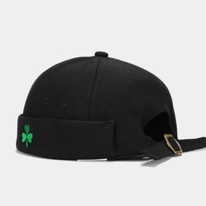 Detail of green clover embroidery on black canvas miki hat with adjustable metal buckle