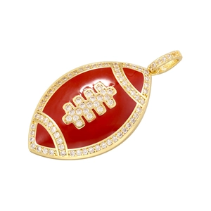 Detail of gold rugby pendant featuring red enamel inlay and sparkling zircon accents