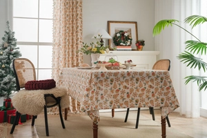 Cozy festive dining scene featuring gingerbread man Christmas tablecloth and curtains