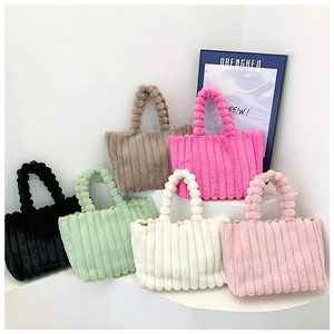Collection of plush striped tote bags in various candy colors on a modern display stand