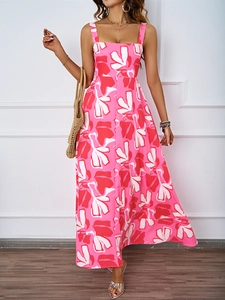 Detailed view of pink floral print on a long A-line summer dress with wide straps