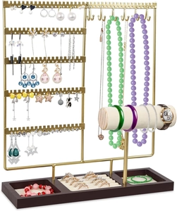 Detail view of gold metal jewelry organizer with wood base for earrings and necklaces