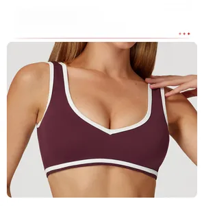 Détail de la bordure contrastée sur le soutien-gorge de sport rouge vin à larges bretelles