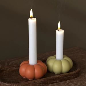 Halloween pumpkin candle holder set with orange and green resin bases and white pillars