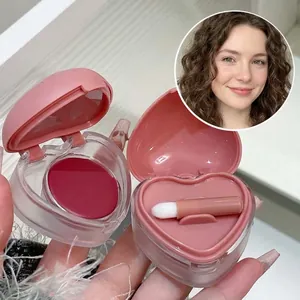 Heart-shaped pink lip and cheek mud cream with a mini applicator brush for makeup