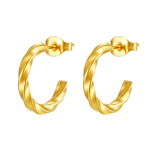 Close-up of twisted 18K gold plated C-shaped earrings with polished spiral texture