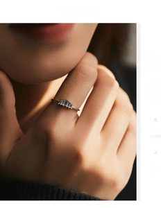 Close-up of S925 sterling silver ring featuring three baguette-cut clear stones on model