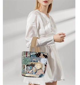 Artistic tote bag featuring lush jungle patterns and animal prints on a studio model