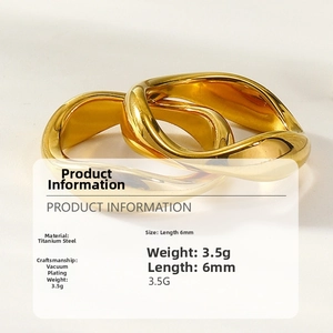 Macro shot of gold-plated twisted wave ring in titanium steel with product dimensions