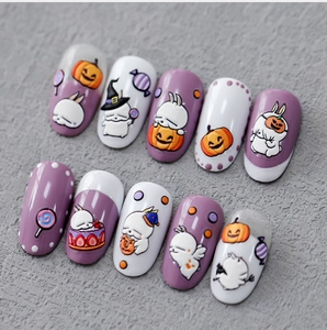 Detail of 3D embossed Halloween press-on nails featuring cute bunny and pumpkin relief
