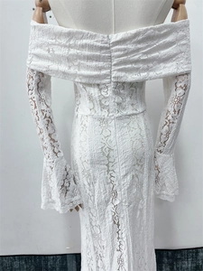 Detailed back view of white lace off-shoulder dress featuring zipper and pleated texture