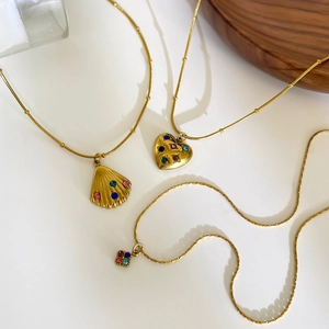 Three gold stainless steel necklaces with shell, heart, and flower colorful stone pendants