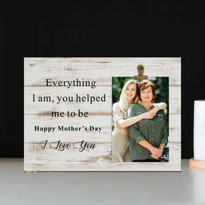 Macro detail of wooden photo holder with Happy Mother's Day text and metal clips