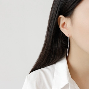 Minimalist S925 sterling silver S-curve long drop earrings on female model