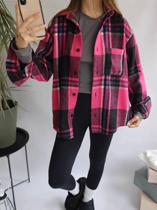 Pink and black plaid flannel shirt with drop shoulders for women in a mirror selfie view