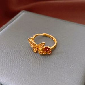 Macro shot of gold-plated butterfly and flower ring with zircon inlay and open design