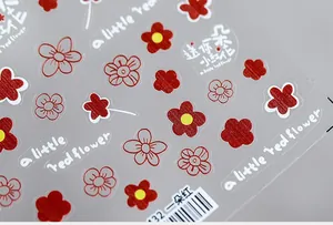 Macro shot of 5D red flower nail stickers with hand-written font and high saturation