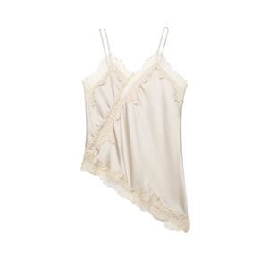 Detail of champagne satin camisole featuring delicate lace trim and irregular hem