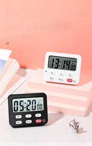 Detail of black and white magnetic digital kitchen timers with large LCD screens