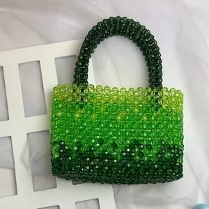 Close-up of handmade green gradient beaded handbag showing textured acrylic crystal beads