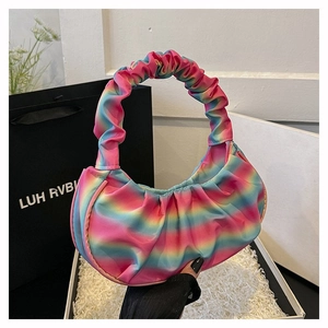 Detailed close-up of rainbow gradient pleated shoulder bag with ruffled handle design