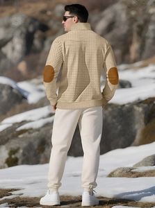 Detail of beige knit sweater featuring brown elbow patches and waffle texture back view