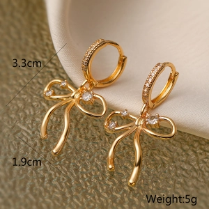 Detail of gold bow earrings with zircons showing dimensions 3.3cm by 1.9cm and 5g weight