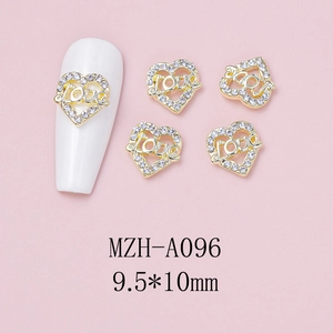 Detail of heart nail charm with LOVE engraving and crystals on golden alloy base