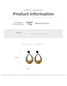 Detail view of crescent resin earrings with gold foil and 7.2cm by 4cm dimensions