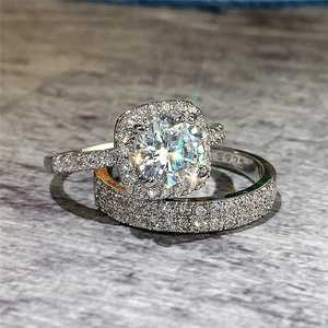 Macro view of S925 sterling silver ring set with round halo cubic zirconia and pavé band