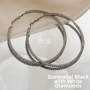 Detailed view of 8cm gunmetal black oversized hoop earrings with sparkling rhinestones