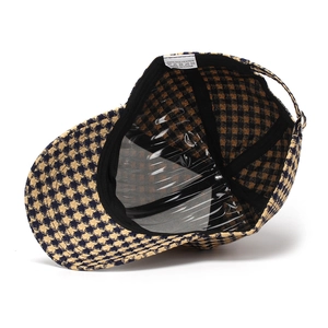 Detail view of houndstooth baseball cap interior with moisture wicking band and wash label