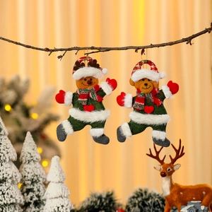 Christmas reindeer and bear fabric hanging ornaments on a branch with warm gold background