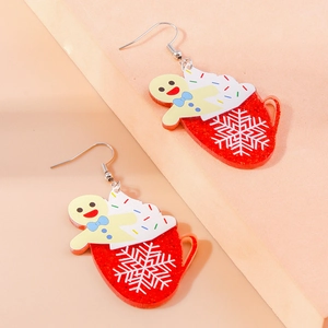 Detail view of festive gingerbread man and snowflake coffee cup acrylic earrings