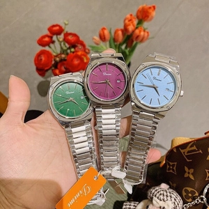 Detailed close-up of fashion square dial watches in green, purple, and blue with steel straps
