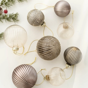 6cm glass Christmas balls in gold glitter and striped gray on white background