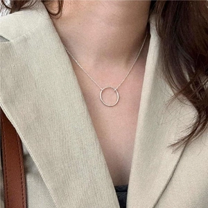 Minimalist S925 sterling silver geometric circle necklace worn on a beige blazer outfit